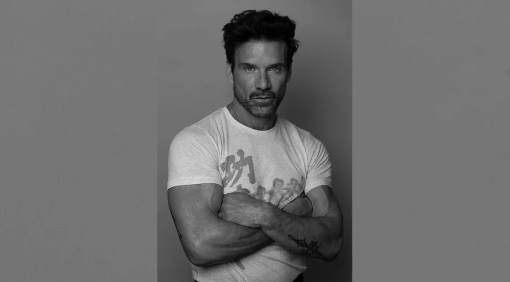 Actor Frank Grillo showing off his muscles in a white tee shirt
